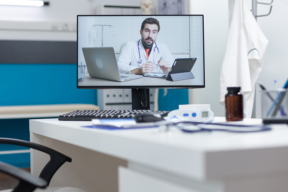 Computer screen with remote doctor having online videocall meeting